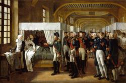 Napoléon s’adresse à Coste qui soulève un blessé, tandis que des invalides décorés de la Légion d’honneur se pressent sur leur passage