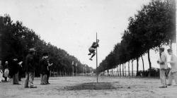 Elle montre un saut à la perche en longueur sur la promenade du Gravier, le long de la Garonne, à Agen.